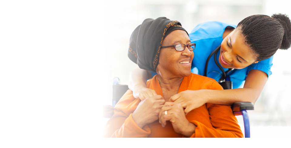 Caregiver hugging her patient