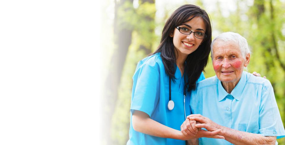 Caregiver holding hands with her patient