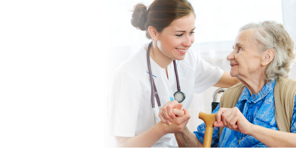 Caregiver helping her patient to get up