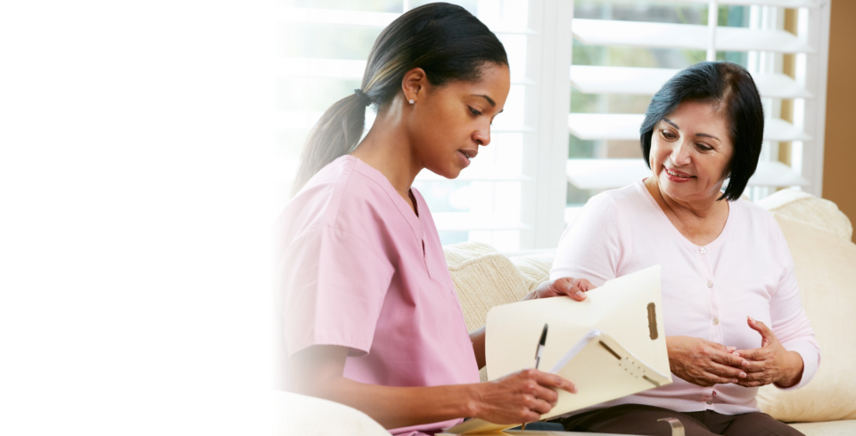 Caregiver assiting her patient with her medicines